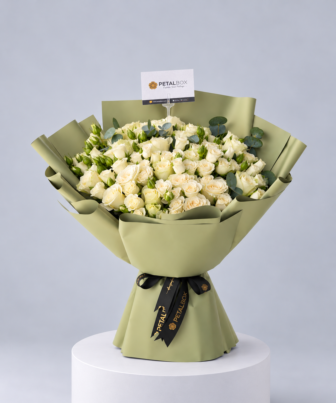 luxury white rose bouquet featuring fresh ivory roses and eucalyptus foliage, wrapped in elegant sage green paper with a black Petal Box ribbon, premium flower delivery in Abu Dhabi and Dubai for anniversaries, birthdays and special occasions