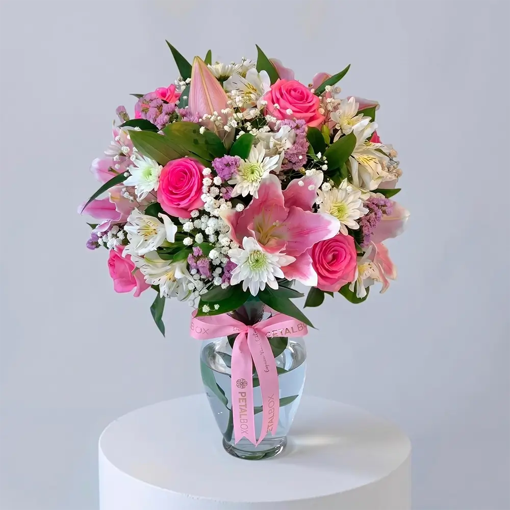 pink lily and rose arrangement in a clear glass vase with white chrysanthemums and baby's breath, elegant floral gift by Petal Box UAE for flower delivery in Abu Dhabi and Dubai