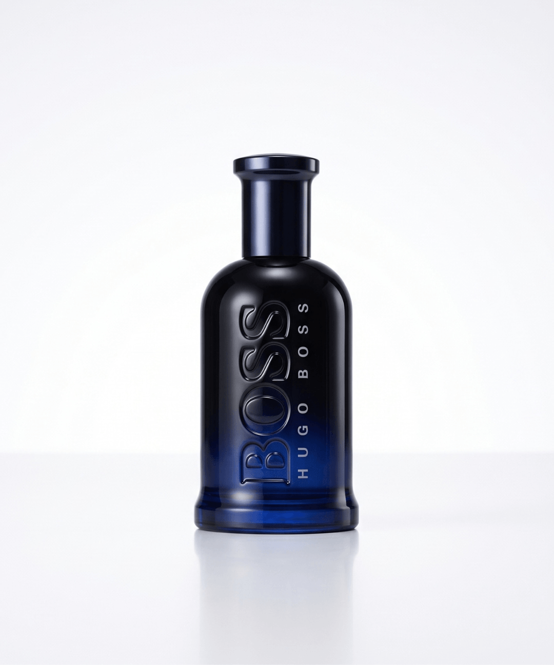 Hugo Boss Bottled Night Eau de Toilette for Men 100ml, featuring a sleek dark navy blue perfume bottle with embossed lettering and matching black and blue packaging, available for men's designer perfume shopping in Abu Dhabi, Dubai and across the UAE.