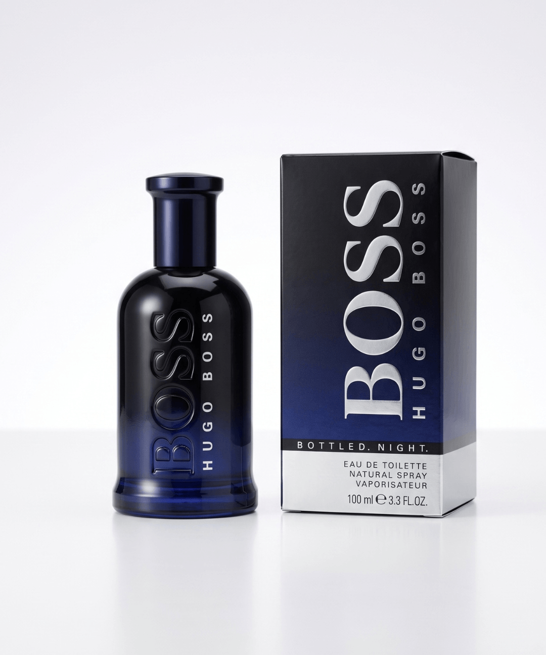 Hugo Boss Bottled Night Eau de Toilette for Men 100ml, featuring a sleek dark navy blue perfume bottle with embossed lettering and matching black and blue packaging, available for men's designer perfume shopping in Abu Dhabi, Dubai and across the UAE.