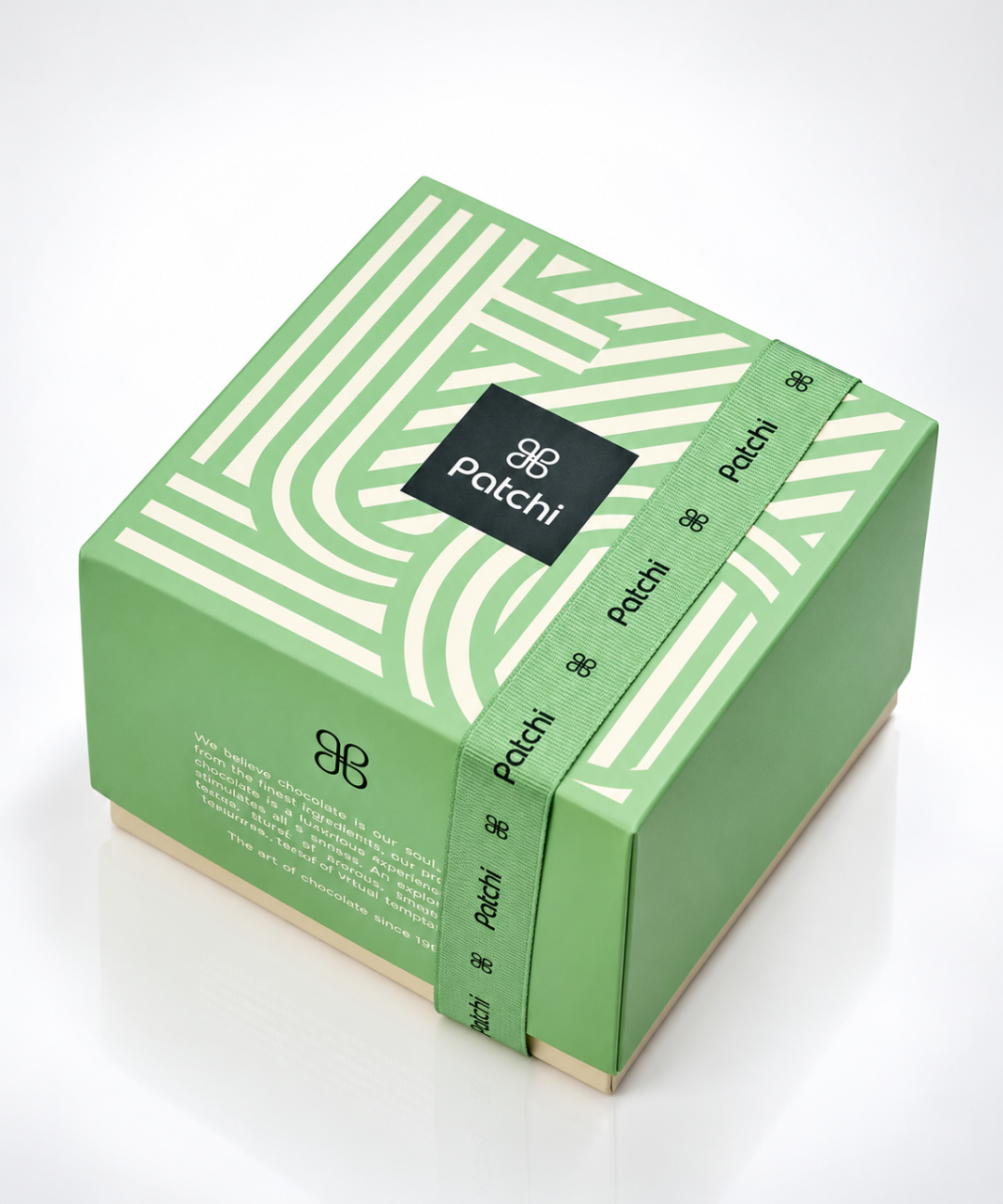 Mint green Patchi chocolate gift set featuring a matching branded shopping bag and geometric-patterned chocolate box with signature green ribbon. Elegant luxury gifting presentation with white Patchi logos and a subtle reflective studio surface.