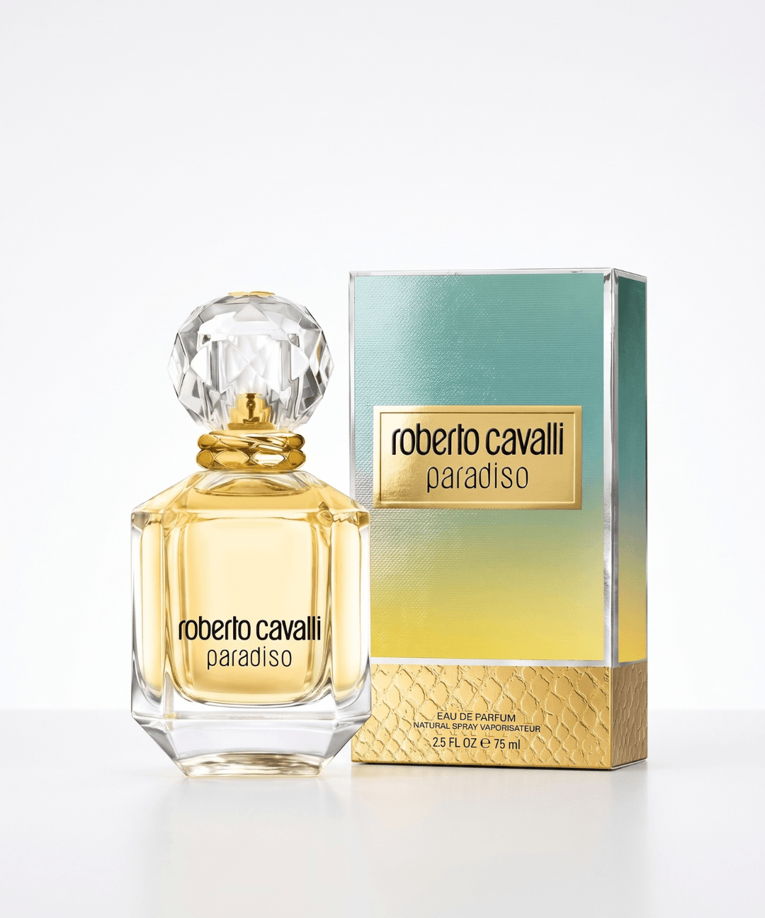 Roberto Cavalli Paradiso Eau de Parfum for Women 75ml, featuring an elegant transparent glass perfume bottle with golden fragrance, a crystal-cut cap and matching turquoise and gold packaging, available for women's luxury perfume shopping in Abu Dhabi, Dubai and across the UAE.