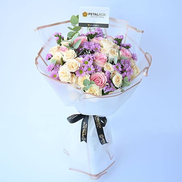 luxury pastel flower bouquet with pink and cream spray roses, lavender chrysanthemums and eucalyptus in premium wrapping, elegant floral arrangement by Petal Box UAE with same day flower delivery in Abu Dhabi and Dubai