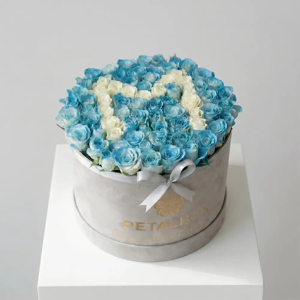 Luxury blue and white rose flower box arrangement with elegant letter design in fresh roses, styled in a premium velvet Petal Box for special gifting occasions.