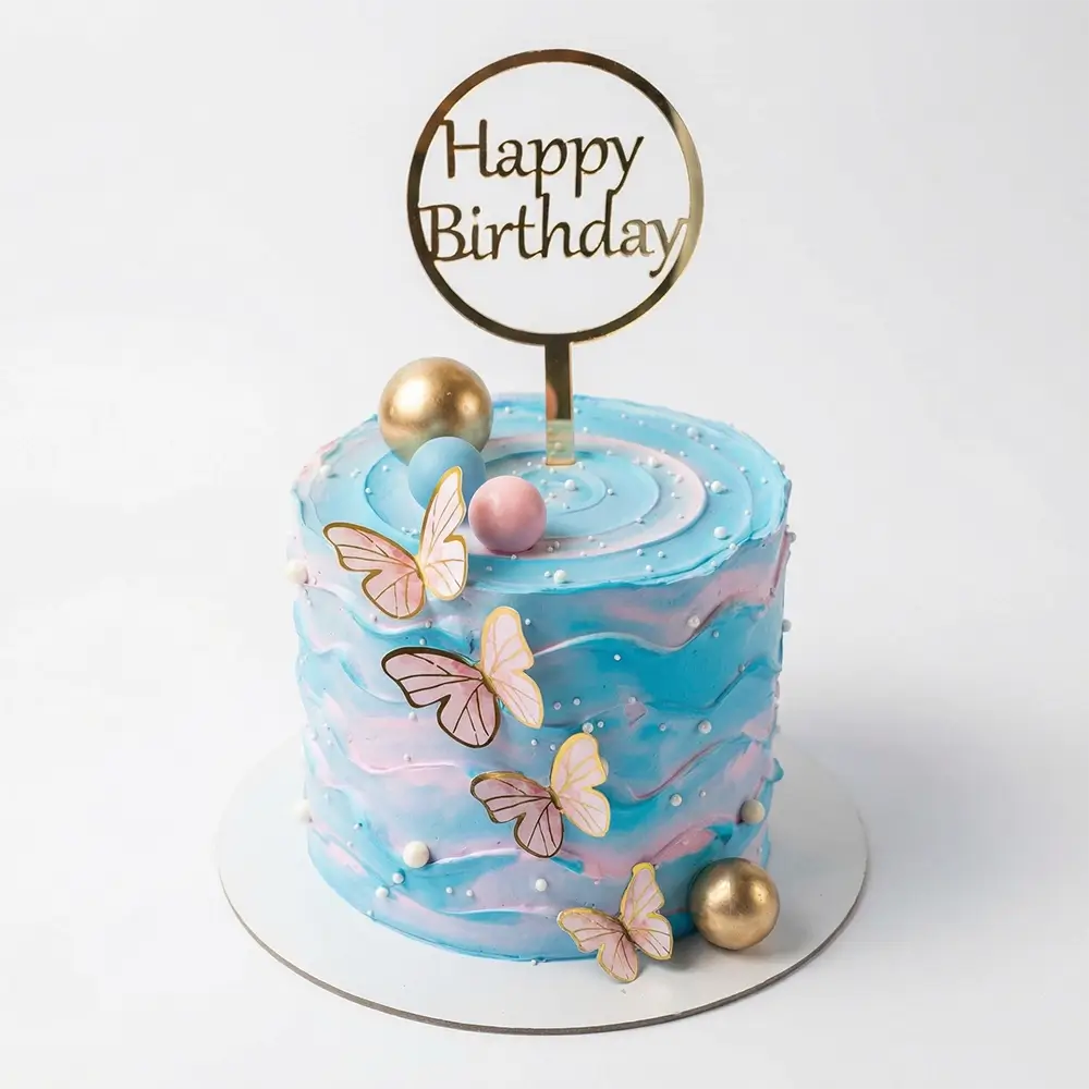 Pastel blue butterfly birthday cake with gold topper – custom birthday cake delivery Abu Dhabi