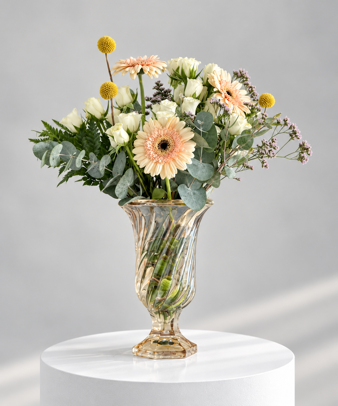 Peach gerbera spray rose and yellow craspedia flower arrangement in a gold vase by Petal Box