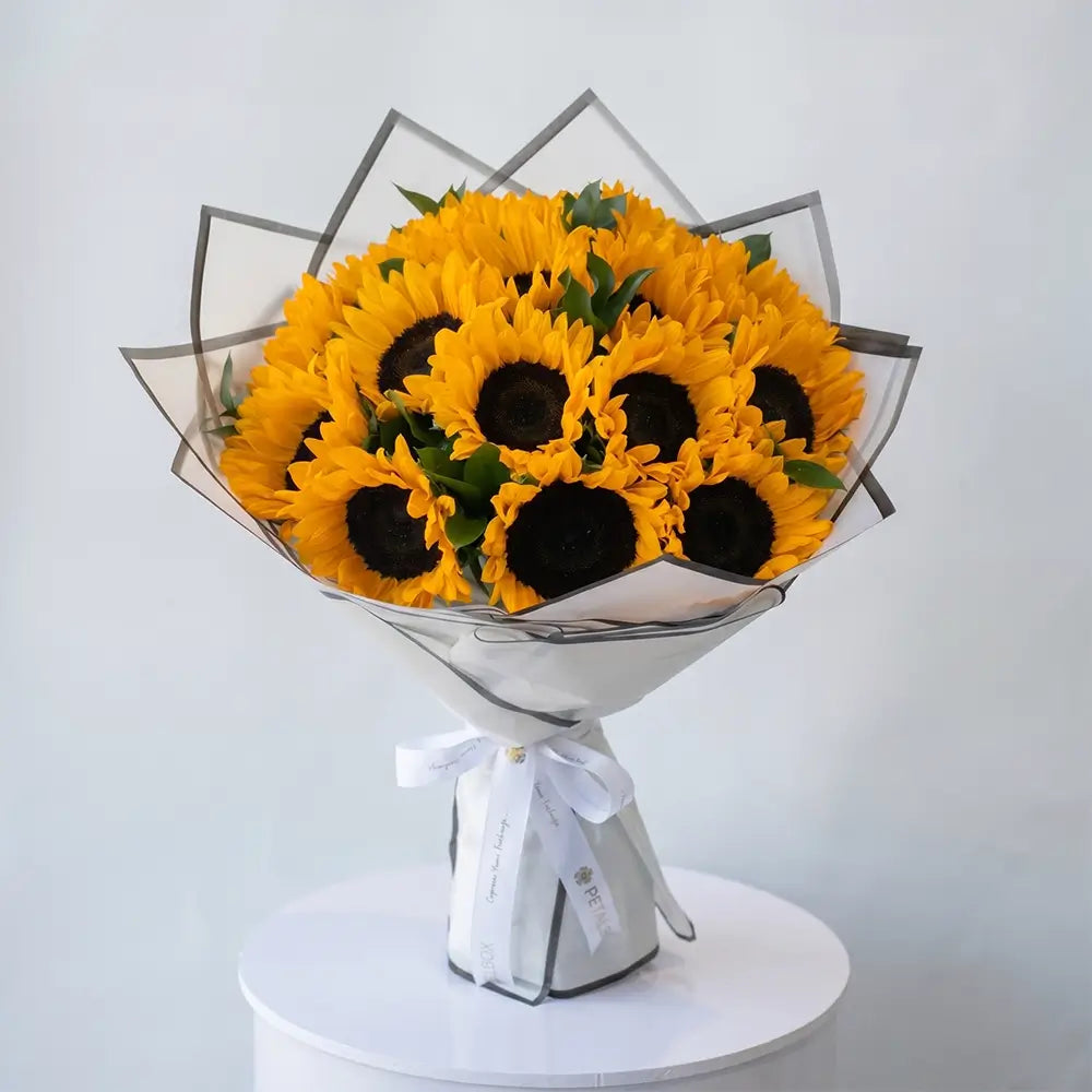 bright yellow sunflower bouquet with fresh sunflowers in elegant white wrapping, cheerful floral arrangement by Petal Box UAE for flower delivery in Abu Dhabi and Dubai