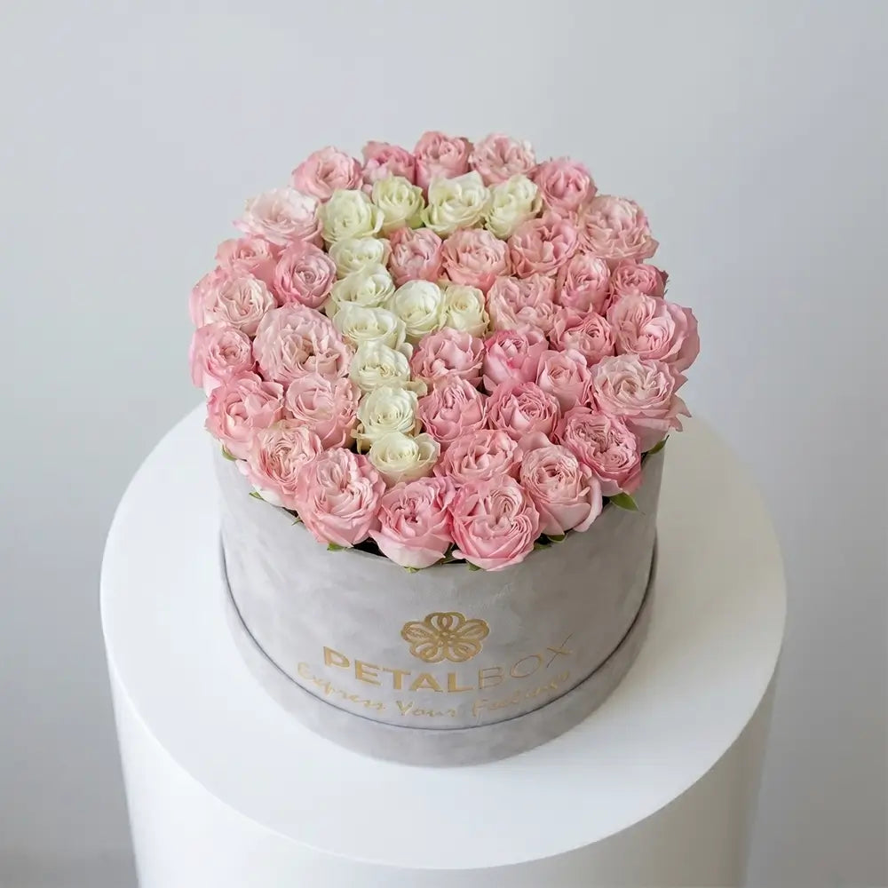 Luxury pink and white heart-shaped rose flower box arrangement in a premium velvet Petal Box, designed for romantic gifting and special occasions.