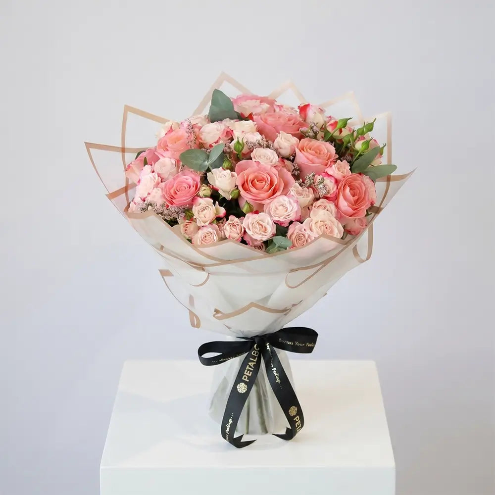 luxury pink and white rose bouquet with premium roses, spray roses and eucalyptus in elegant wrapping, romantic floral arrangement by Petal Box UAE for flower delivery in Abu Dhabi and Dubai