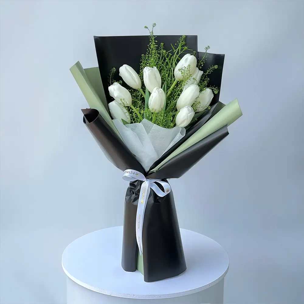 White tulip flower bouquet with lepidium leaves in Black and olive green wrapping