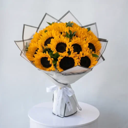 bright yellow sunflower bouquet with fresh sunflowers in elegant white wrapping, cheerful floral arrangement by Petal Box UAE for flower delivery in Abu Dhabi and Dubai
