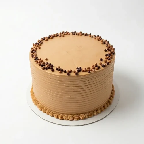 Chocolate Fantasy Crunch Cake with milk chocolate buttercream, crispy pearl border, and elegant ridged frosting