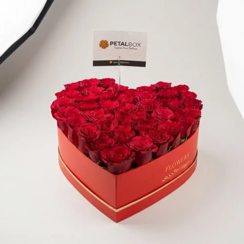 luxury red rose heart box with fresh premium red roses in elegant heart shaped flower box, romantic floral gift by Petal Box UAE for flower delivery in Abu Dhabi and Dubai