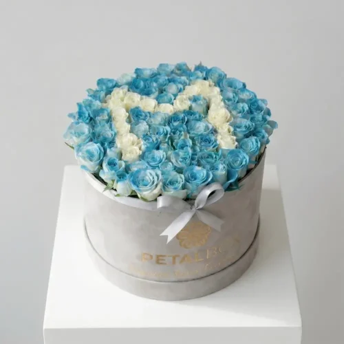 Luxury blue and white rose flower box arrangement with elegant letter design in fresh roses, styled in a premium velvet Petal Box for special gifting occasions.