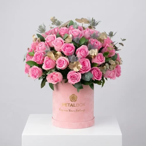 luxury pink rose flower box with fresh premium pink roses, eucalyptus and gold preserved foliage in elegant velvet box, romantic floral arrangement by Petal Box UAE for delivery in Abu Dhabi and Dubai