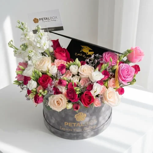 graduation flower box with mixed roses and seasonal blooms, luxury floral arrangement with graduation cap card, premium gift by Petal Box UAE for delivery in Abu Dhabi and Dubai