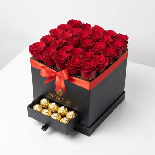 Luxury red rose gift box arrangement with Ferrero Rocher chocolates in a premium black Petal Box, styled with elegant ribbon for romantic gifting and special occasions.