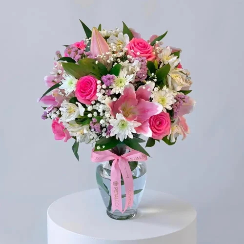 pink lily and rose arrangement in a clear glass vase with white chrysanthemums and baby's breath, elegant floral gift by Petal Box UAE for flower delivery in Abu Dhabi and Dubai