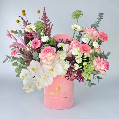 Elegant pink flower box arrangement with roses, orchids, gerbera daisies, and eucalyptus in a luxury Petal Box gift container