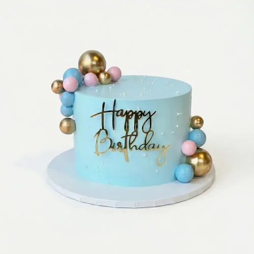 Blue birthday cake with gold, pink and blue decorative ball clusters and gold Happy Birthday topper, Petal Box Abu Dhabi