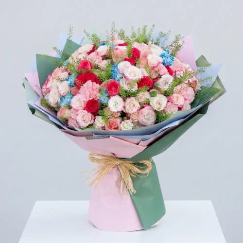 Luxury pastel garden bouquet with pink and white roses, blue hydrangeas, mixed seasonal flowers, and elegant pastel wrapping for premium gifting and special occasions by Petal Box.