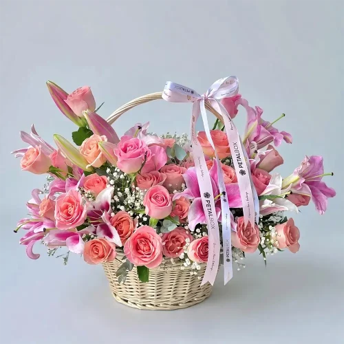 Pink Lily Rose Flower Basket with pink lilies, pink Hermosa roses, gypsophila, eucalyptus, and green leaves by Petal Box for gifting in Abu Dhabi, Dubai & across UAE