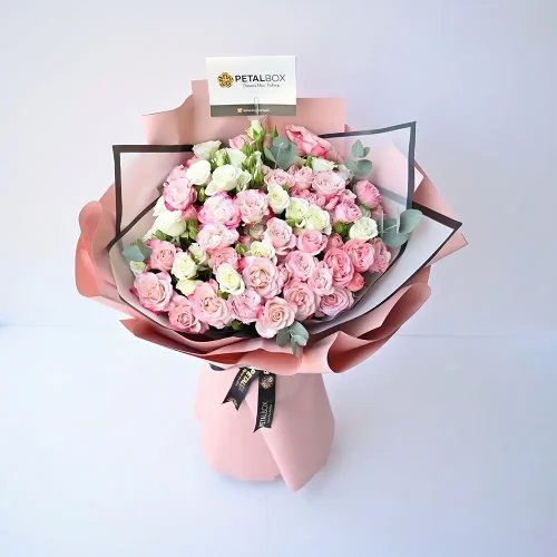 pink and white mixed spray roses bouquet with eucalyptus, wrapped in blush paper, premium flower arrangement by Petal Box UAE for delivery in Abu Dhabi and Dubai
