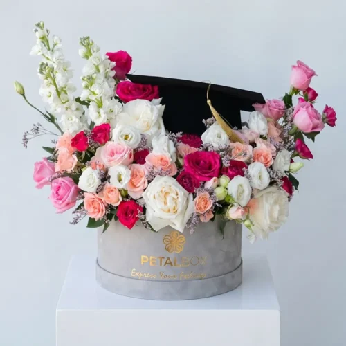 graduation flower box with mixed roses and seasonal blooms, luxury floral arrangement with graduation cap card, premium gift by Petal Box UAE for delivery in Abu Dhabi and Dubai