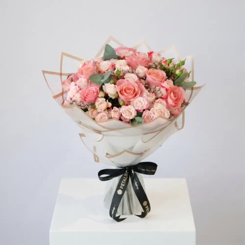 Luxury pink rose and spray rose bouquet with elegant premium wrapping, soft blush tones, eucalyptus accents, and black Petal Box ribbon for sophisticated gifting and special occasions.