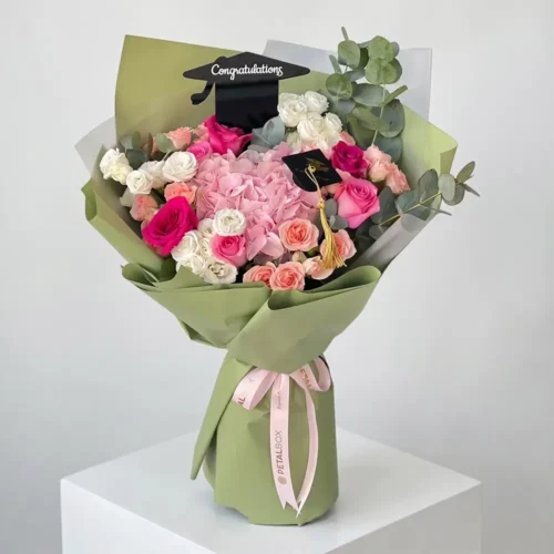 Pink hydrangea graduation bouquet with fuchsia roses and white lisianthus in olive green wrap, Petal Box UAE