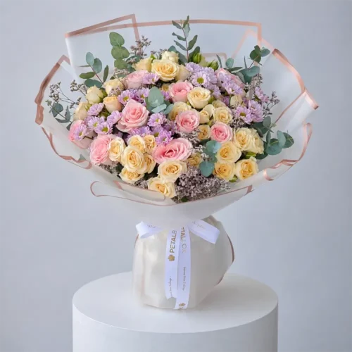 luxury pastel flower bouquet with pink and cream spray roses, lavender chrysanthemums and eucalyptus in premium wrapping, elegant floral arrangement by Petal Box UAE with same day flower delivery in Abu Dhabi and Dubai